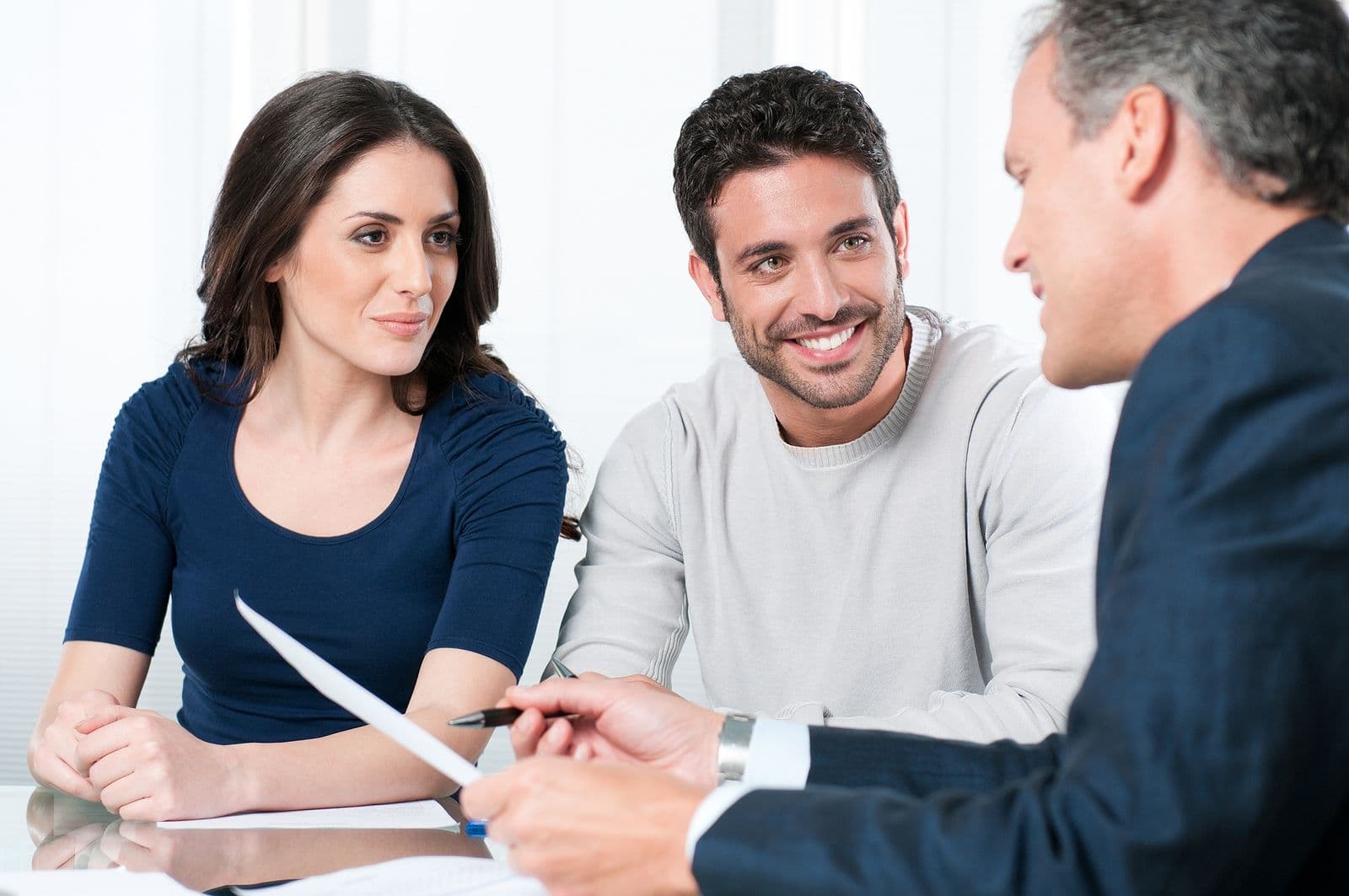 A financial consultant presents options to a young couple.