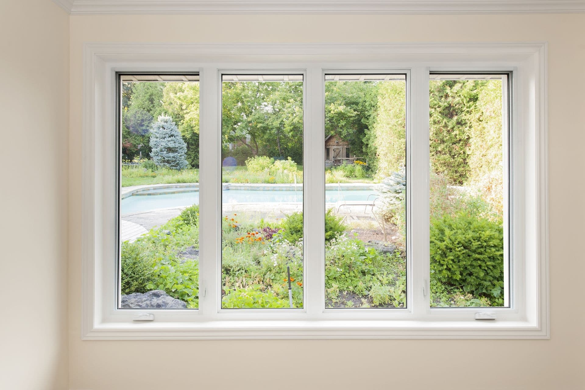 Large four-pane window looking out at a yard.