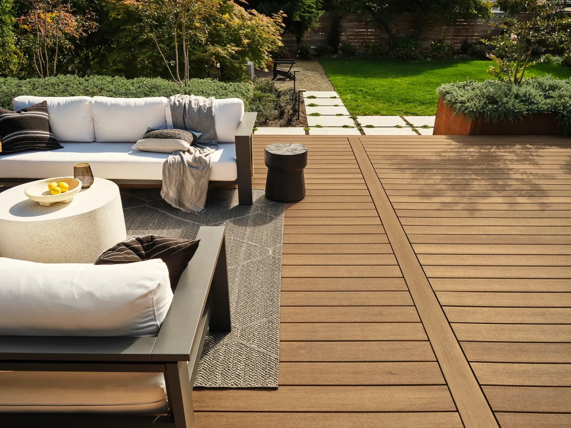 A new brown TimberTech deck with patio furniture.