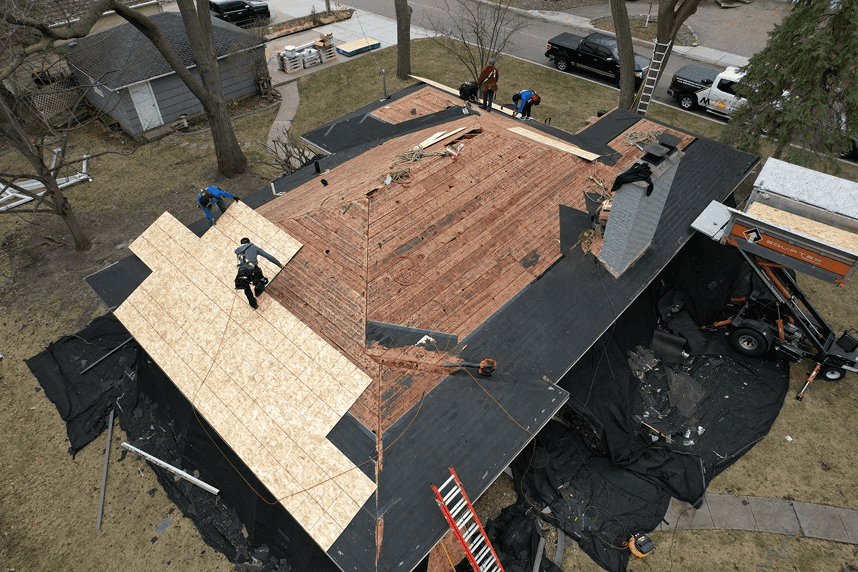 An aerial view of workers installing new roofing.