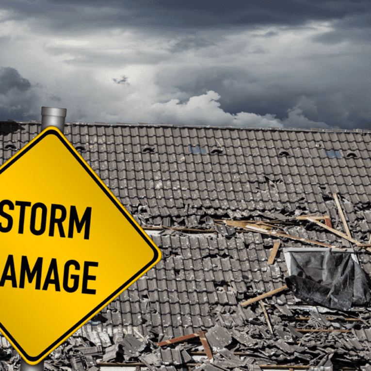 A sign reads "Storm Damage" in front of a damaged tile roof.