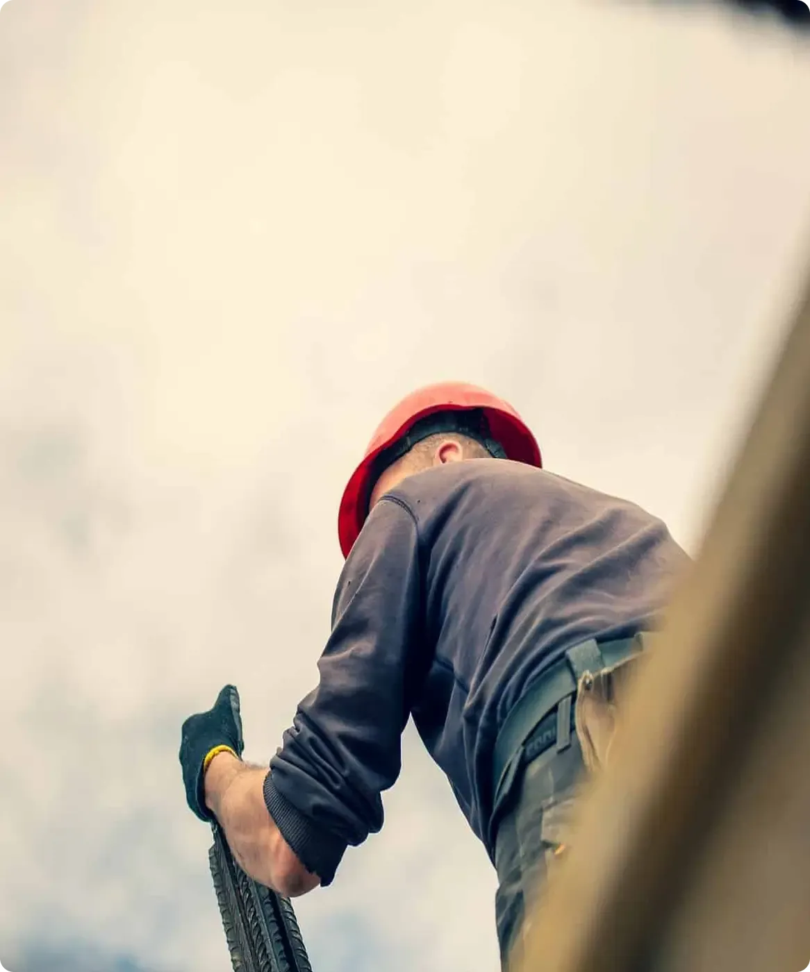 A worker installs roofing.