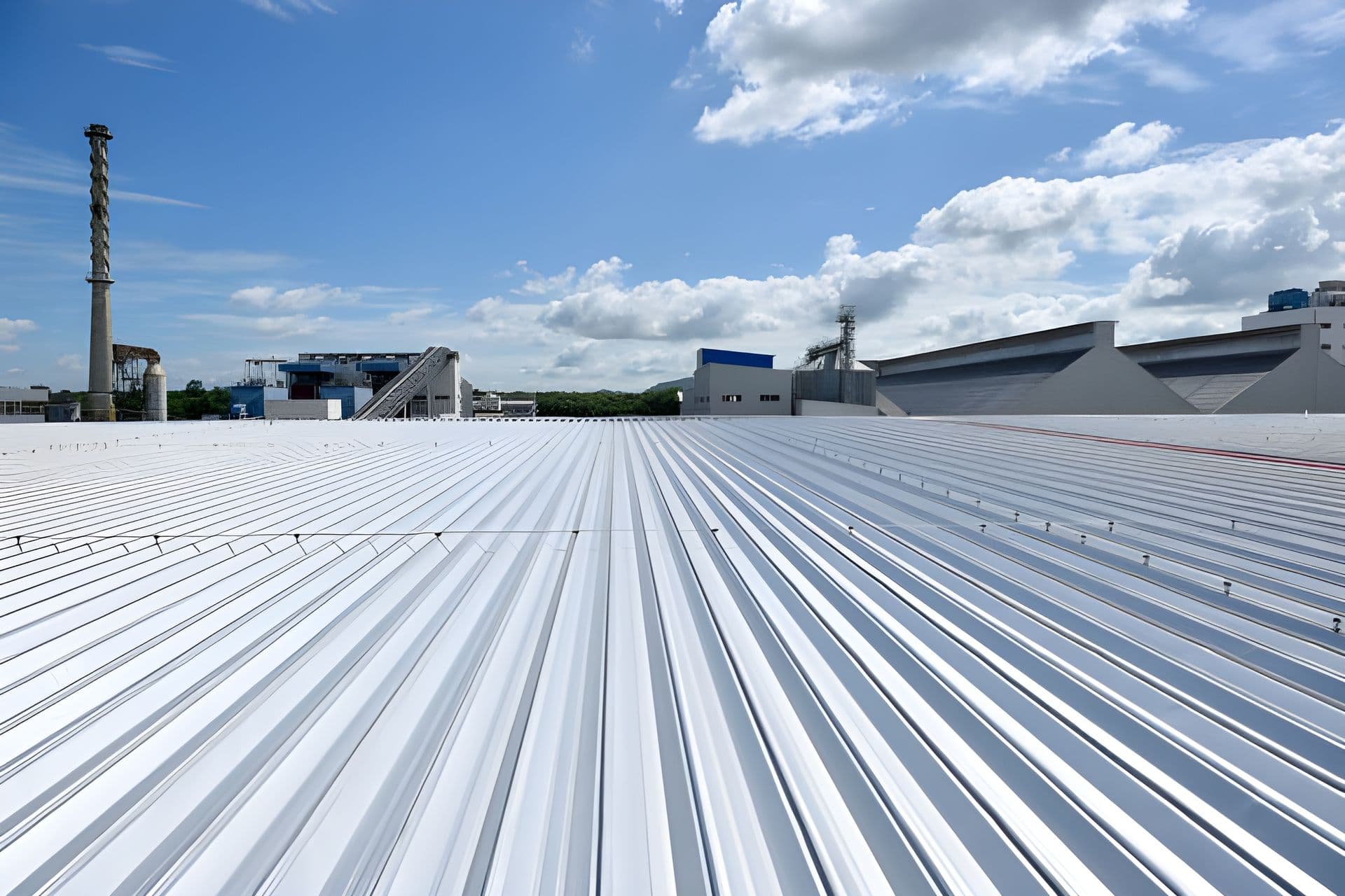 A commercial building with a new, white, metal roof.