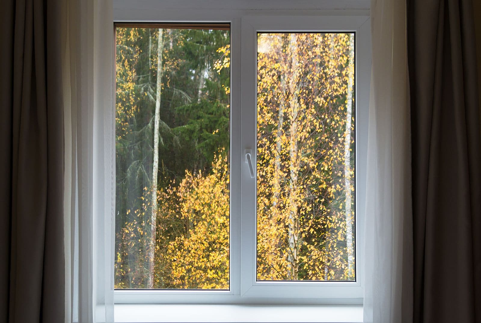 Casement windows overlook fall foliage.