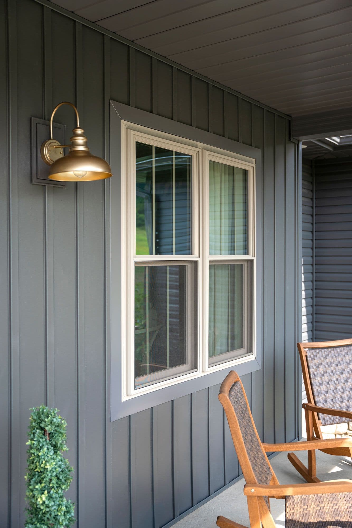 New ProVia double-hung windows on a house with vertical gray siding.
